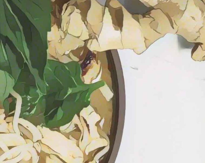 Bowl of noodle soup with spinach and ginger